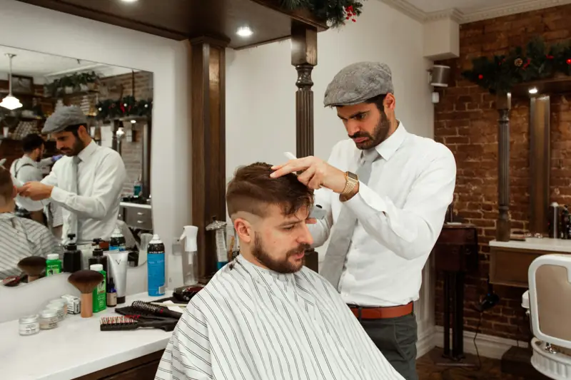 A barber cutting a client's hair