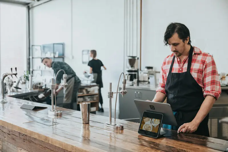 A cafe owner at the counter