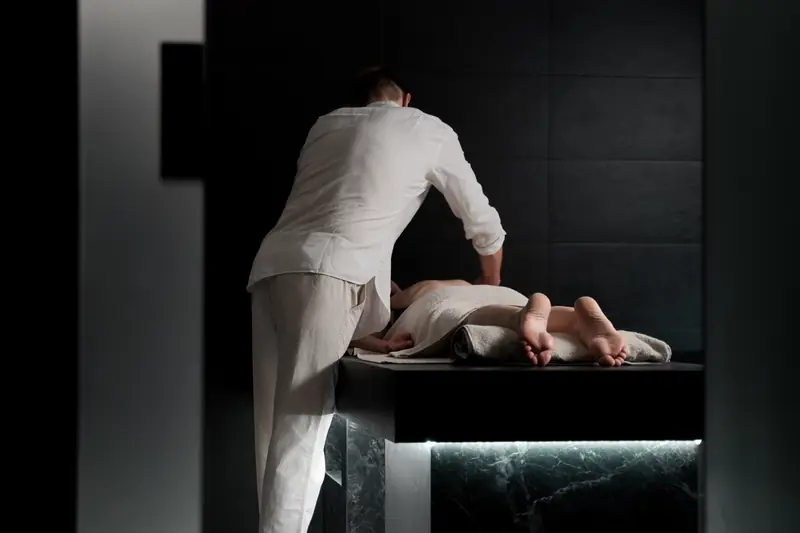 A massage therapist working with a client