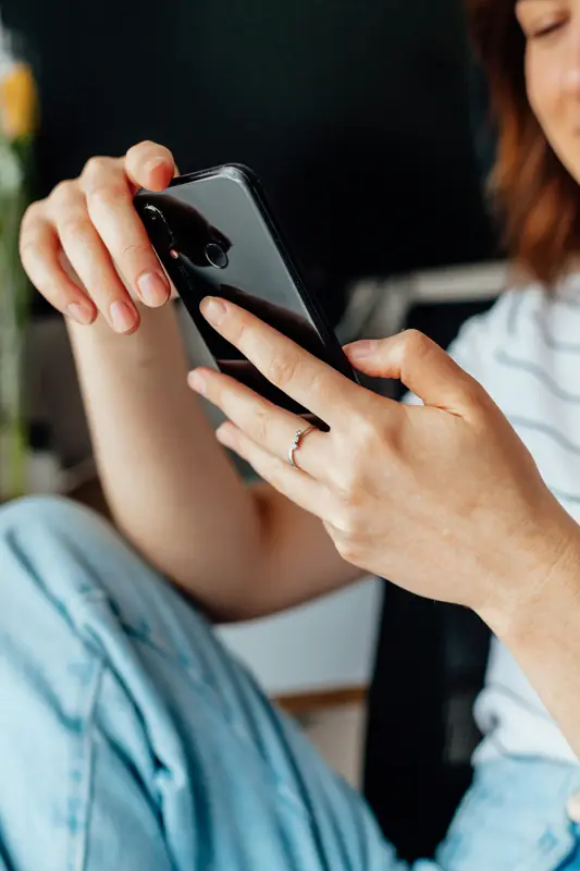 A woman reading a message on her phone
