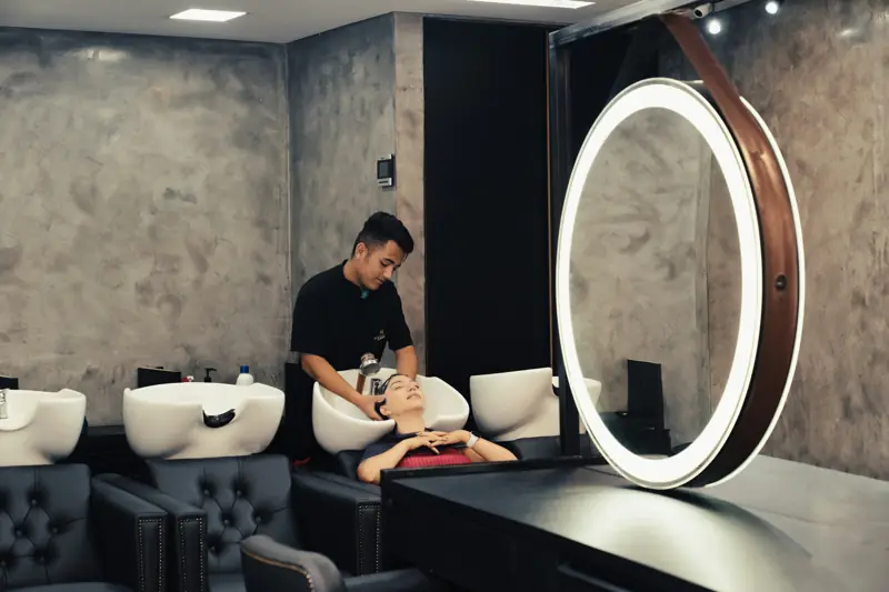 A stylist washing a client's hair