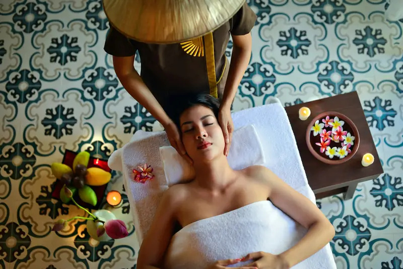 A spa therapist giving a client a face massage